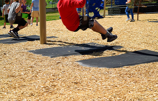APS swing mat under a kid on a swing