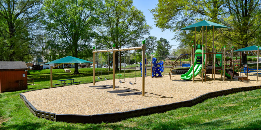 Playground featuring equipment from Action Play Systems
