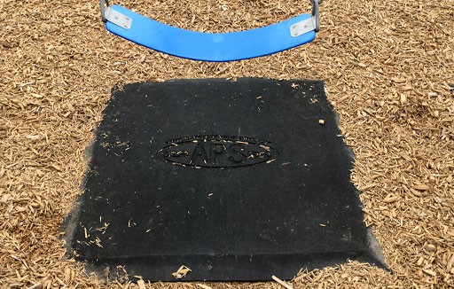 swing wear mat on a playground